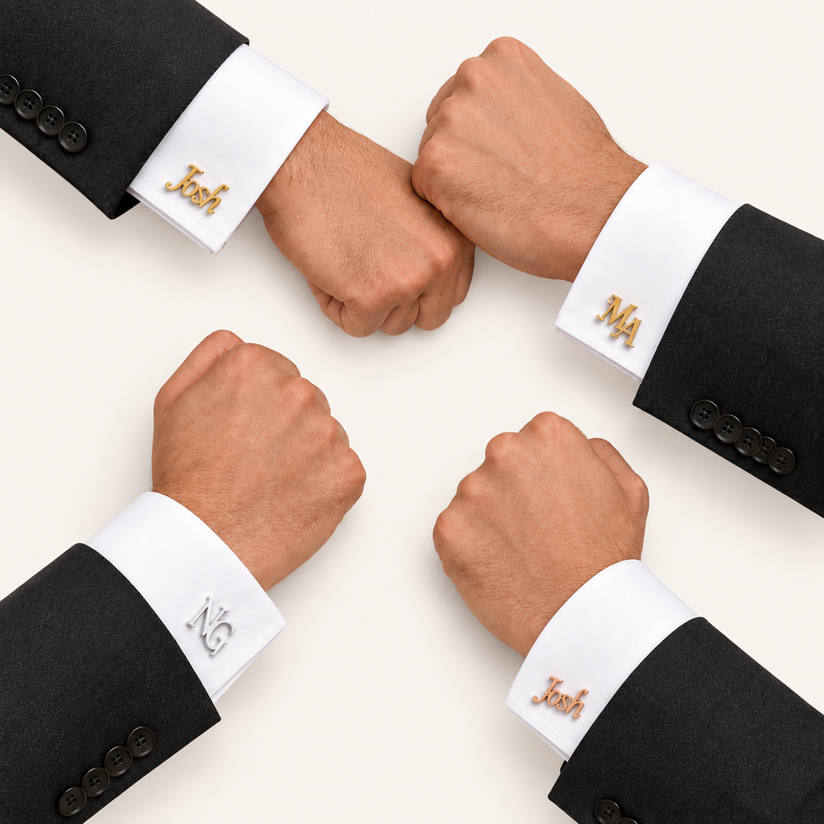 Four men's wrists in black suit jackets and white dress shirts pose for a fist bump, each wearing a custom gold or silver cufflink with a nameplate spelling 'Josh' or 'MA'.